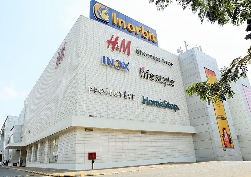 Malad West_a large building with a sign on the side of it