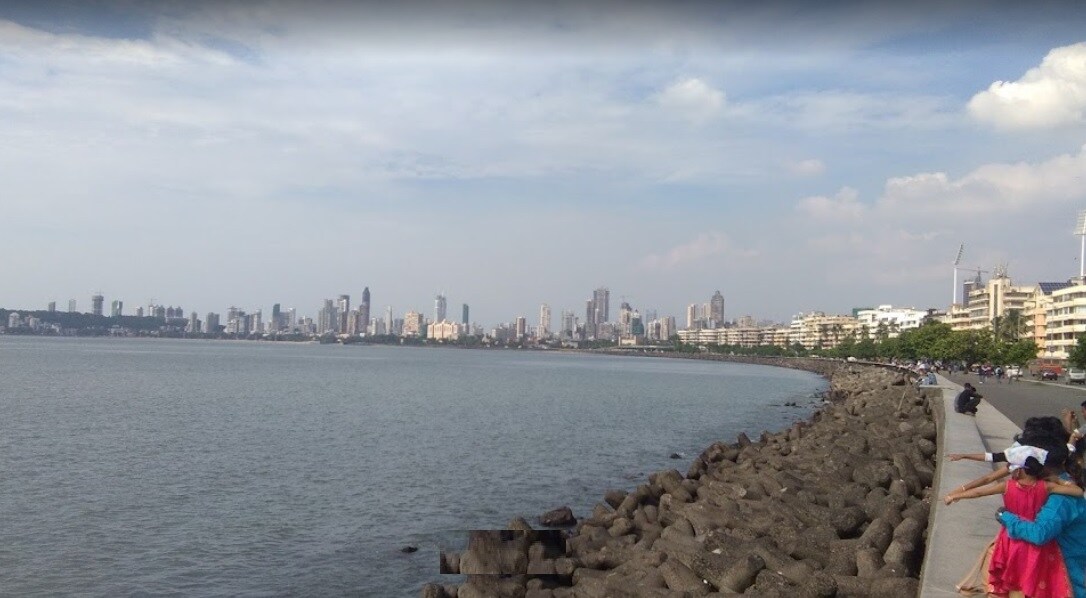 Mandvi_people walking along a beach near a body of water