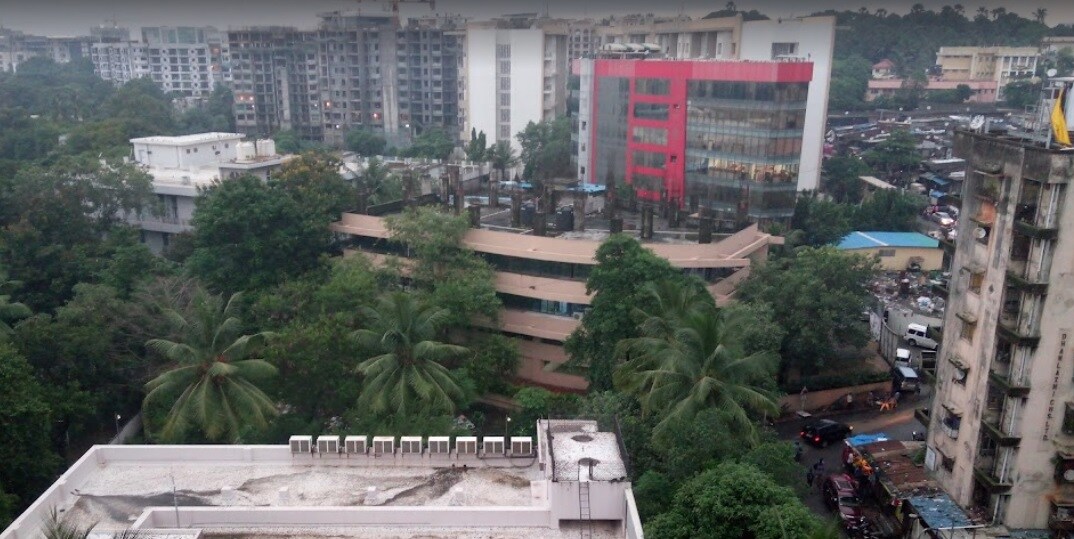 MIDC_a large building with a lot of trees