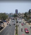 Pratap Nagar_a street filled with lots of cars and motorcycles