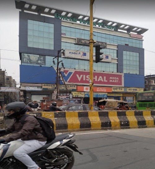 Sangam Vihar_a person riding a motorcycle on a city street