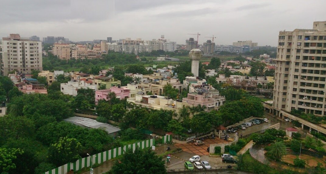 Adarsh Nagar_a city with tall buildings and trees
