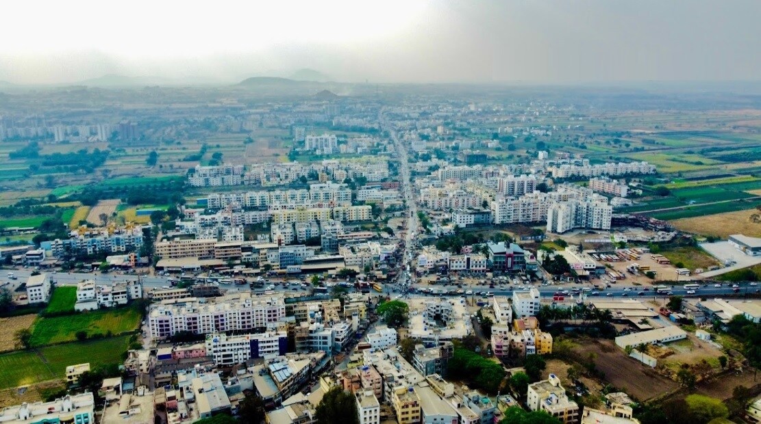 Chakan_a city with tall buildings and a sky background