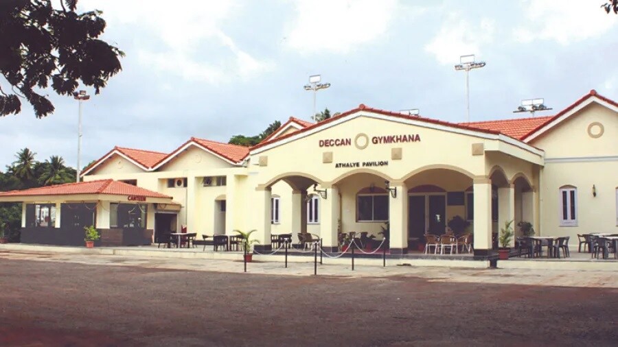 Deccan Gymkhana_a large building with a lot of windows in front of it