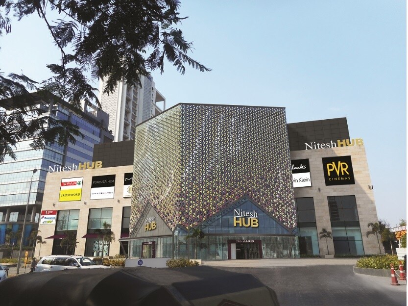 Koregaon Park_a large building with a clock on the front of it