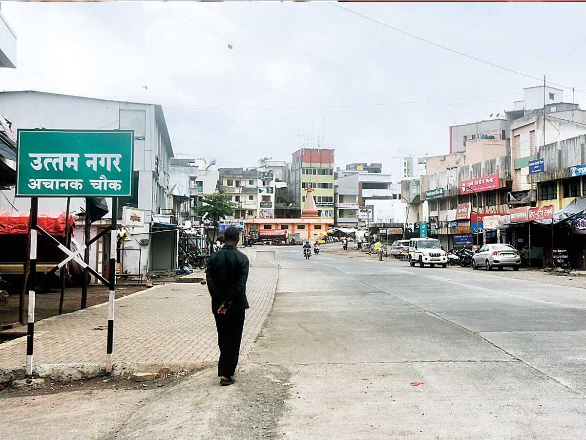 Uttam Nagar_a man walking down a street in a city