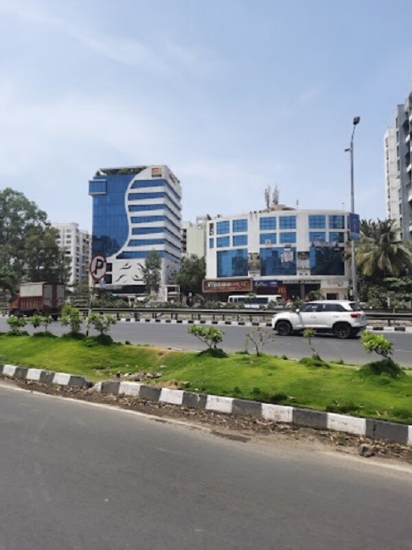 Warje_a car parked on the side of a road near a building