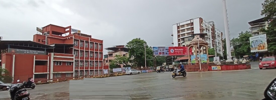 Ambernath East_a street scene with a man riding a motorcycle down the street