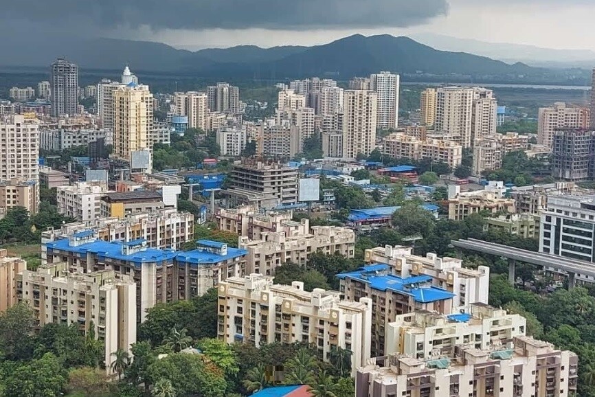 Anand Nagar_a city with tall buildings and a sky background