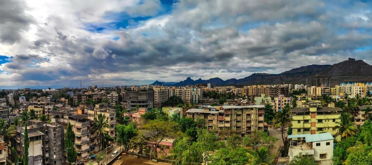 Badlapur_a city skyline with buildings and mountains
