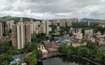 Kasarvadavali_a city with tall buildings and a river