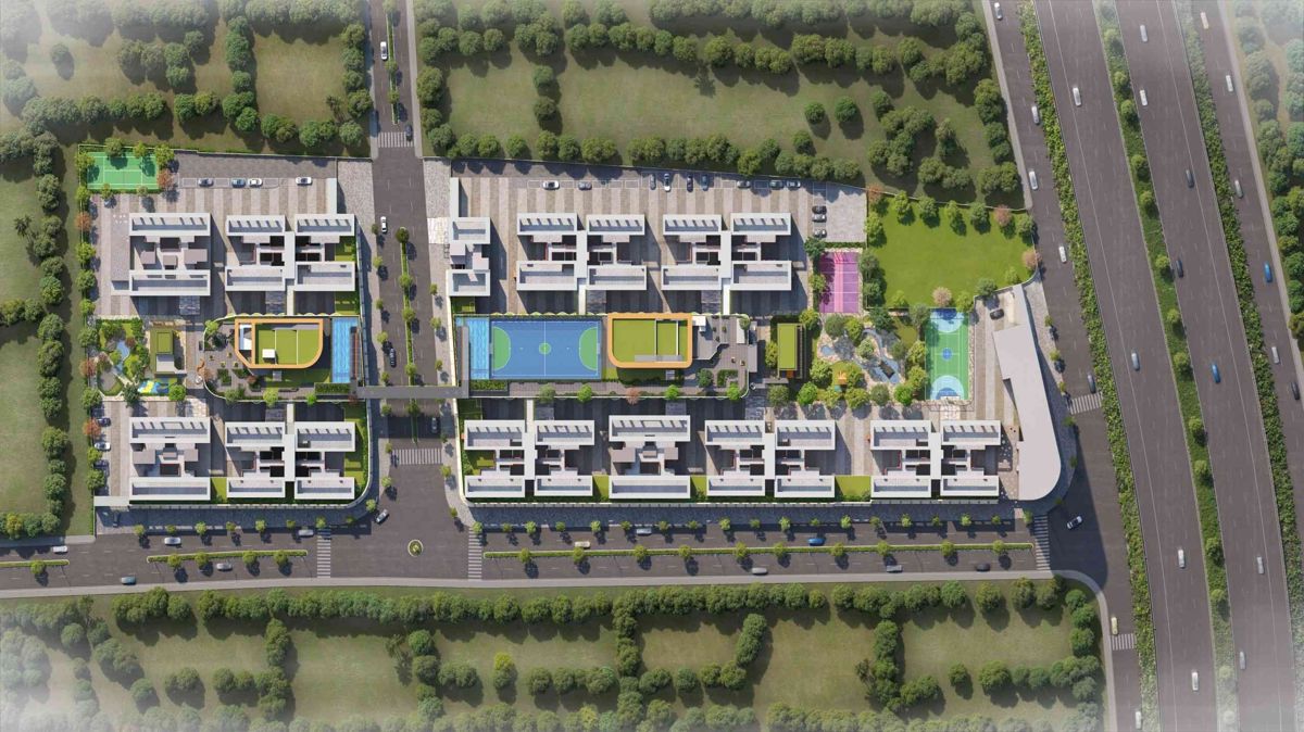 Goyal-My-Home-Sanctuary_an aerial view of a city with a train on the tracks