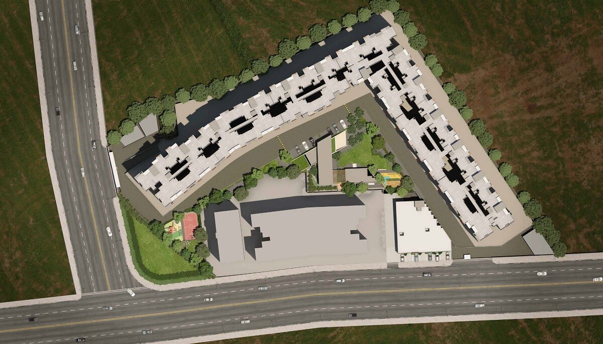 Rama-Krystal-One_an aerial view of a large building with a plane flying over it