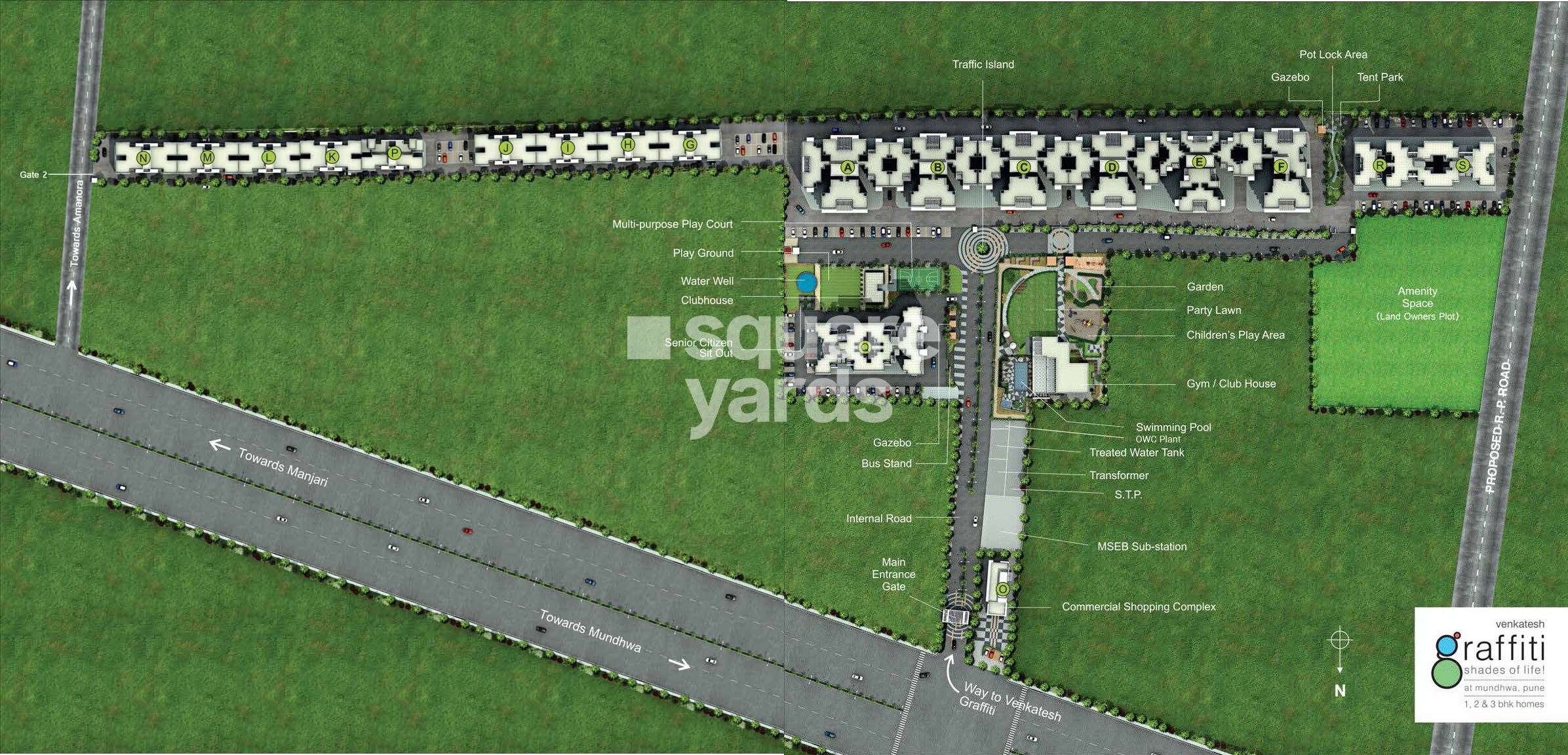 Venkatesh-Graffiti_an aerial view of a grassy area with a train on the track
