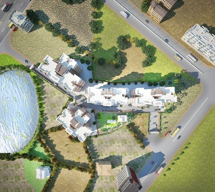 Pakshal-Garden-City_an aerial view of a large building with a plane flying over it